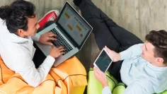 two-business-men-working-tablet-laptop-2-scaled